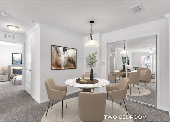 A room with a round table and chairs and a painting on the wall.
