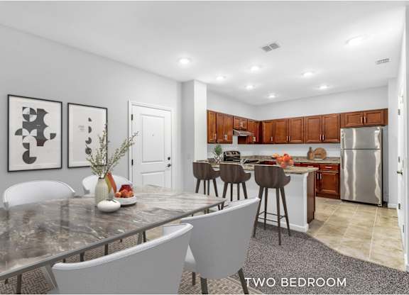 A modern kitchen with a dining table and chairs.