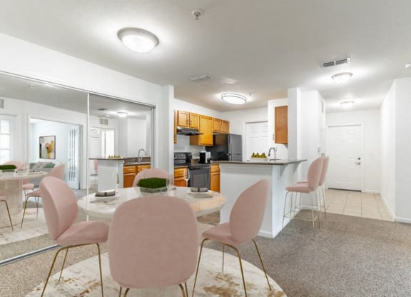 a dining room and kitchen with a table and chairs