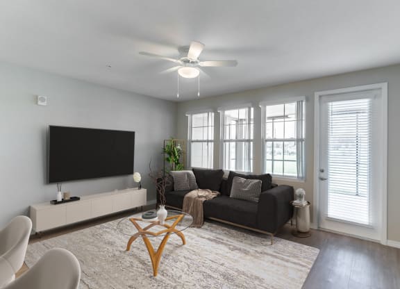 an open living room with a couch and a large tv