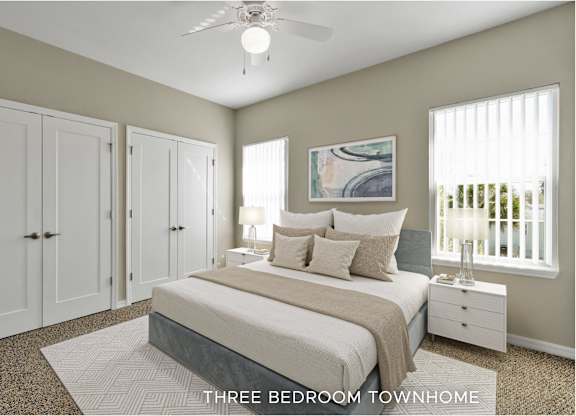 A bedroom with a bed, a ceiling fan, and a painting on the wall.