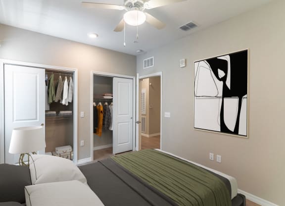 a bedroom with a bed and a ceiling fan
