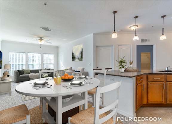 A kitchen with a table set for four.