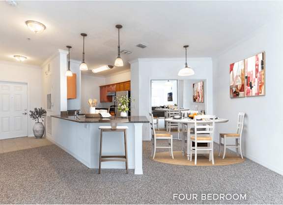 A kitchen with a dining table and chairs is shown in the image.