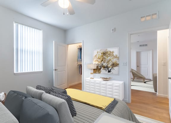 a bedroom with a bed and a white dresser with a yellow blanket