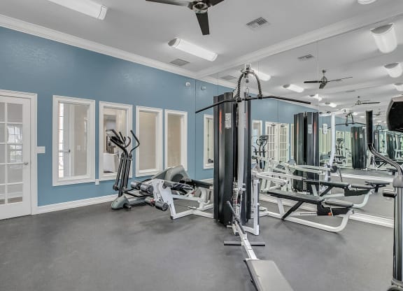 fitness center with equipment and mirror