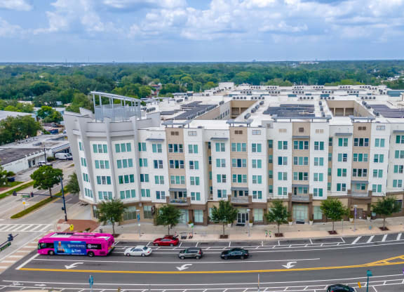 a large white building with a parking lot in front of it