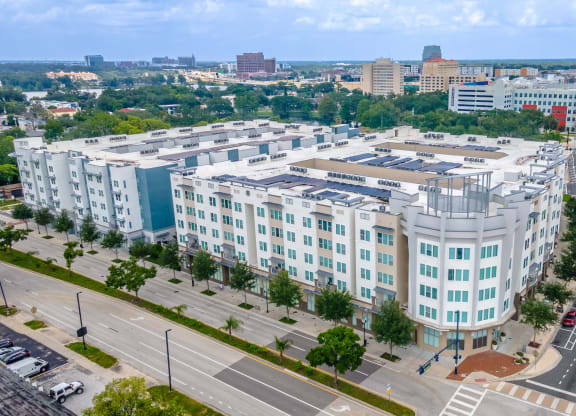 an aerial view of a large white building with many windows