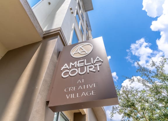 a sign for the amelia court at creative village is shown in front of a blue sky