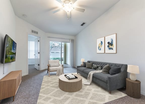 a living room with white walls and a gray couch
