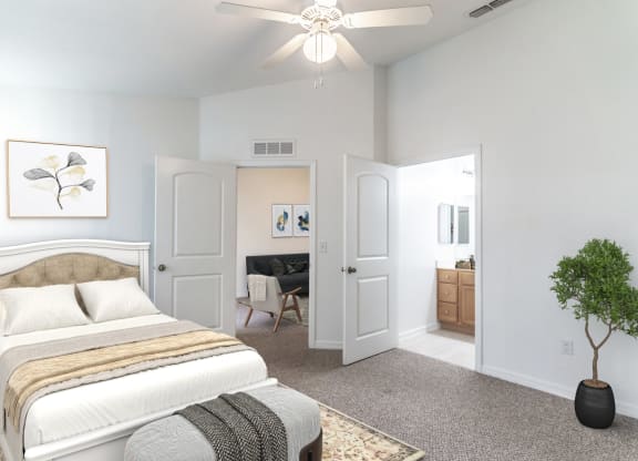 a bedroom with a bed and a ceiling fan