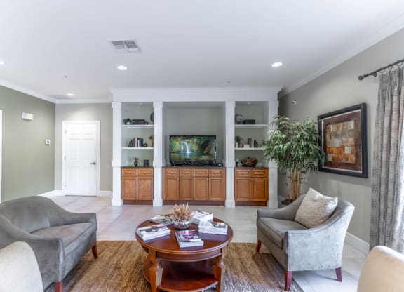 a living room filled with furniture and a flat screen tv