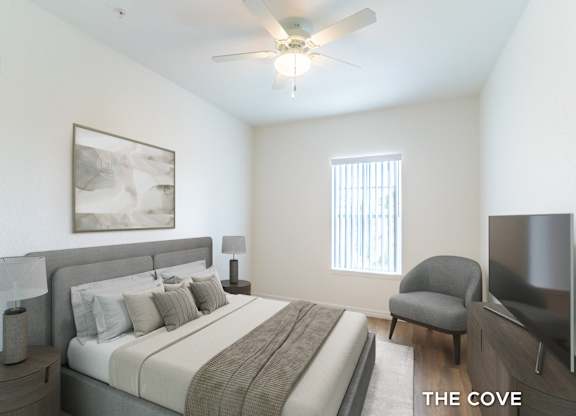A bedroom with a bed, chair, and a painting on the wall.