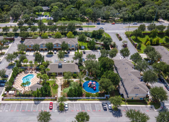 an aerial view of a community with several houses and a swimming pool