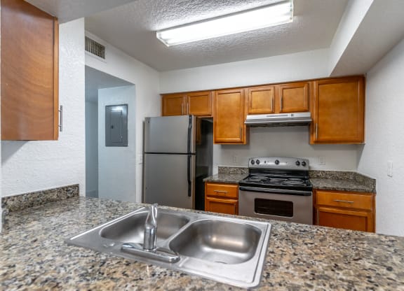 a kitchen with granite countertops and stainless steel appliances