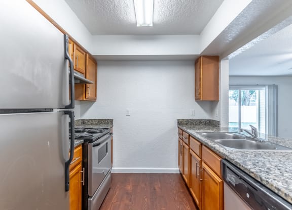 a kitchen with granite countertops and stainless steel appliances