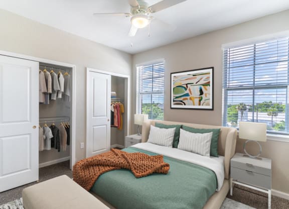 a bedroom with a bed and a ceiling fan