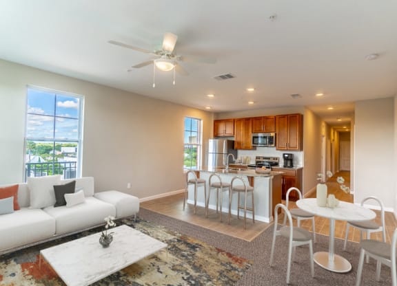a living room and kitchen with a couch and a table