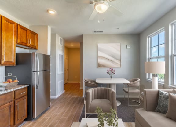 a living room with a kitchen and a table and chairs