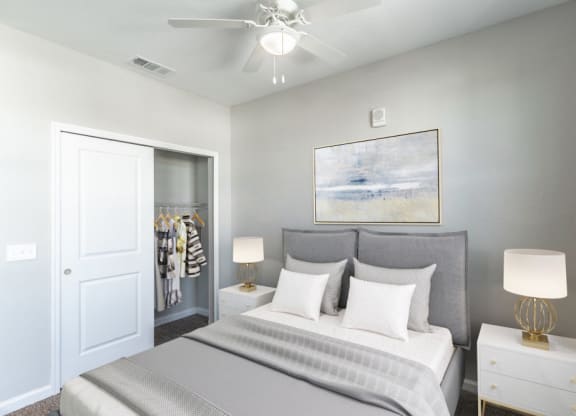 a bedroom with a bed and a ceiling fan
