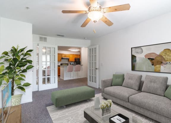 a living room with a couch and a ceiling fan