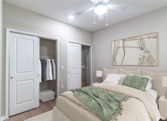 a bedroom with a bed and a ceiling fan