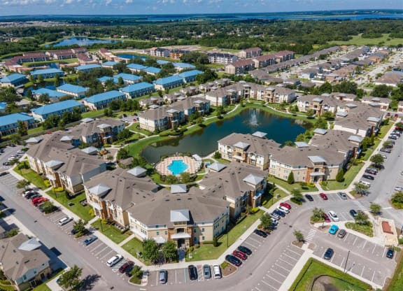 an aerial view of a community with a large lake in the middle of it