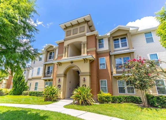 a large apartment building with a walkway in front of it