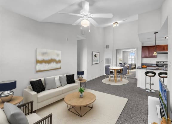 a living room with a couch a table and a ceiling fan