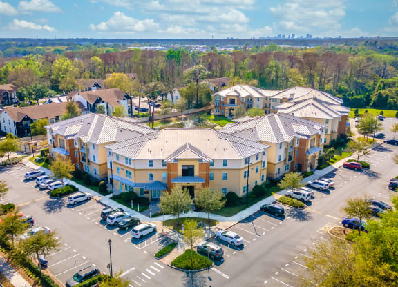 an aerial view of a large apartment complex with cars parked in the parking lot