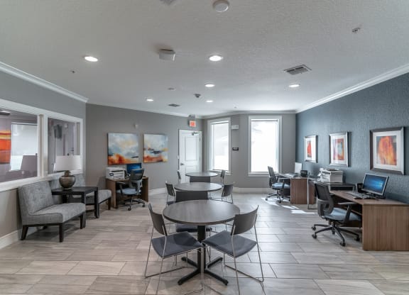 a resident clubhouse with tables and chairs