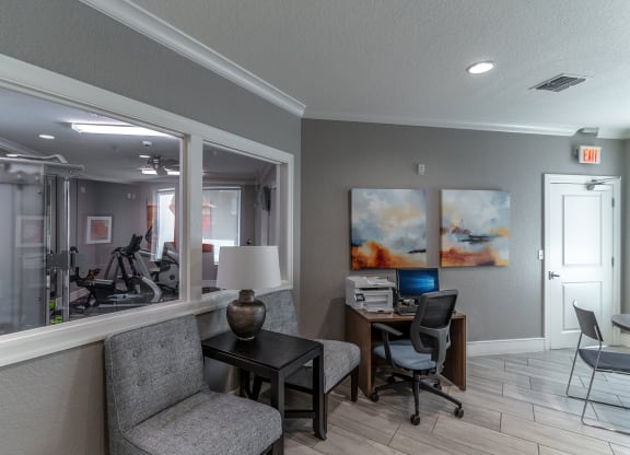 a room with a desk and chair and a mirror
