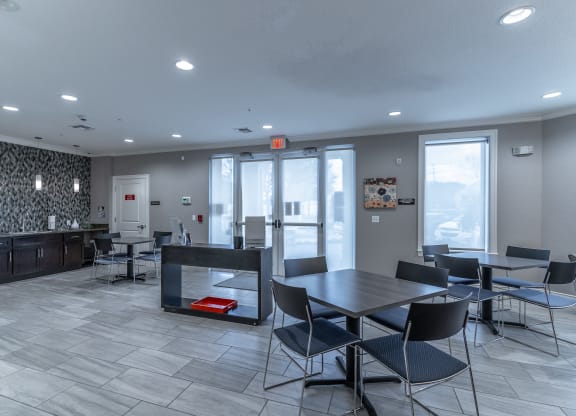 a dining area with a table and chairs