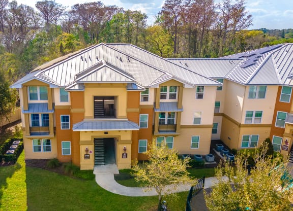 an aerial view of a large apartment building with a metal roof