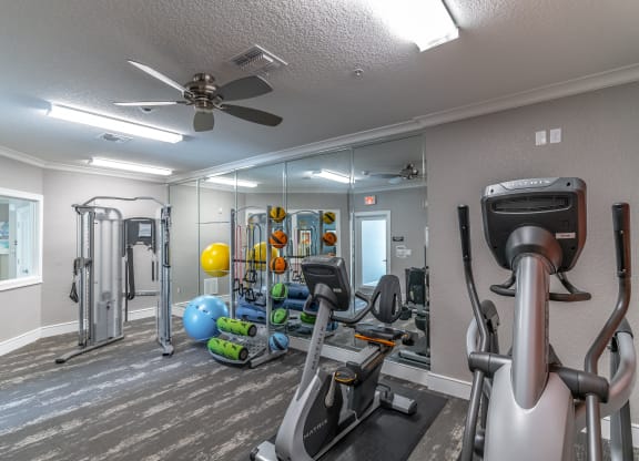 fitness center with equipment and mirror