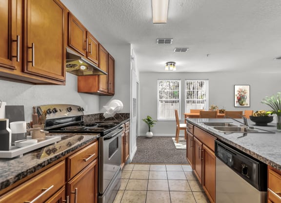 a kitchen with wooden cabinets and stainless steel appliances