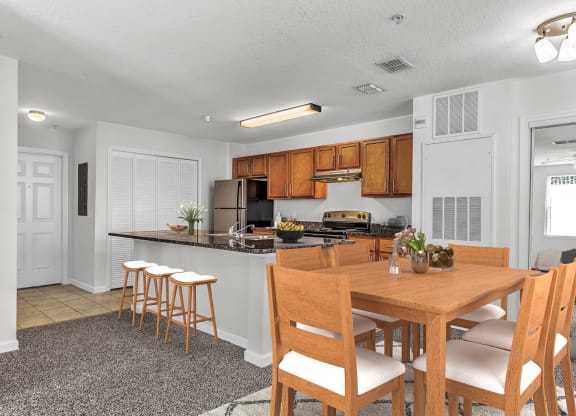 a kitchen and dining area with a wooden table and chairs