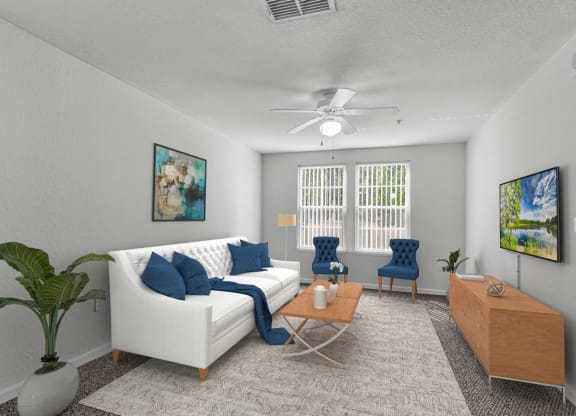 a living room with a white couch and blue chairs