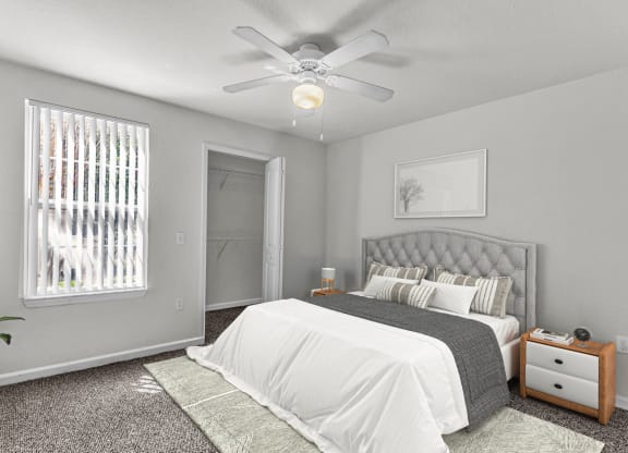 a bedroom with a bed and a ceiling fan