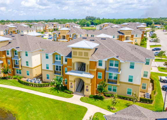 an aerial view of a large complex with a lake in front of it