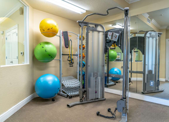 fitness center with equipment and mirror