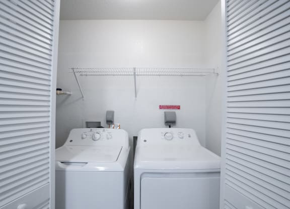 the laundry room has two washers and two dryers