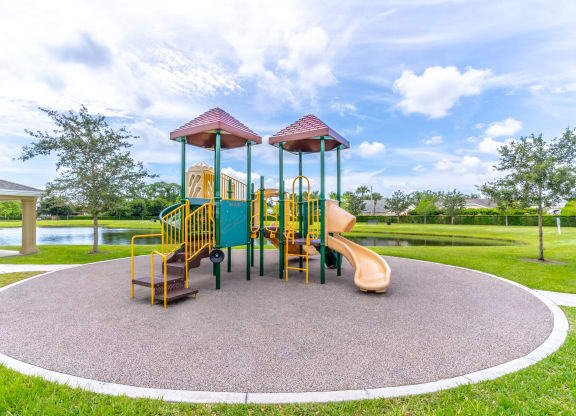 a playground with a slide and monkey bars in the middle of a grassy area