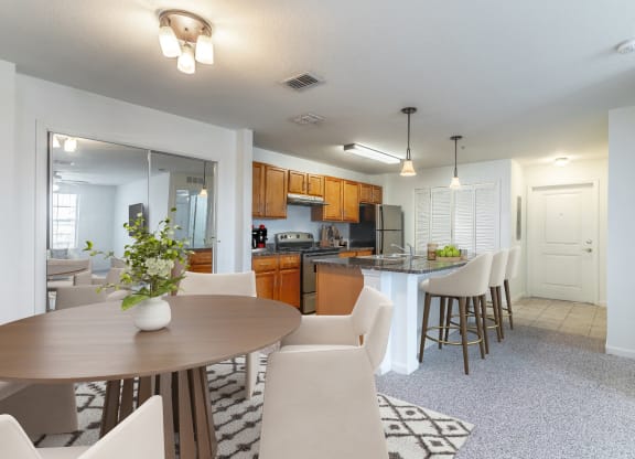 a kitchen and dining area with a table and chairs