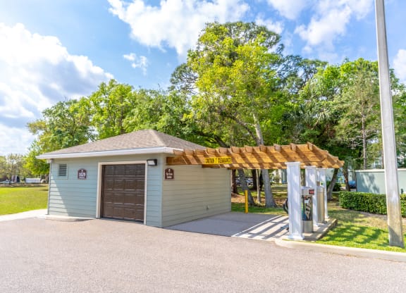a small car care center with a garage and a pergola