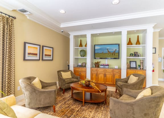 a clubhouse filled with furniture and a flat screen tv
