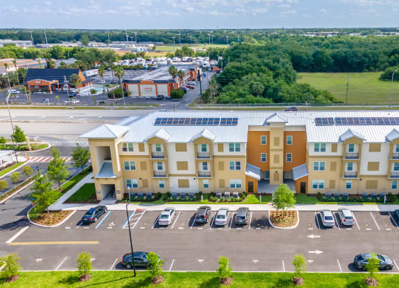 a large apartment building with solar panels on the roof