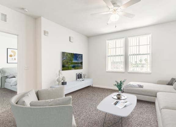 a living room with white walls and a white ceiling fan