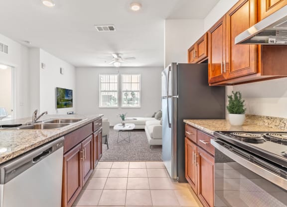 a kitchen with wooden cabinets and stainless steel appliances