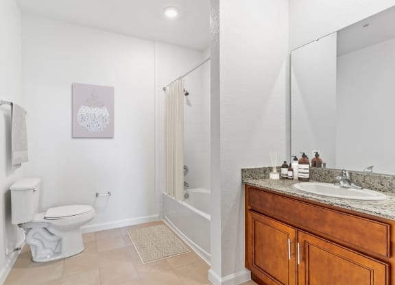 a bathroom with a toilet sink and shower